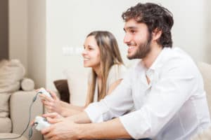 Young couple playing video games in their apartment