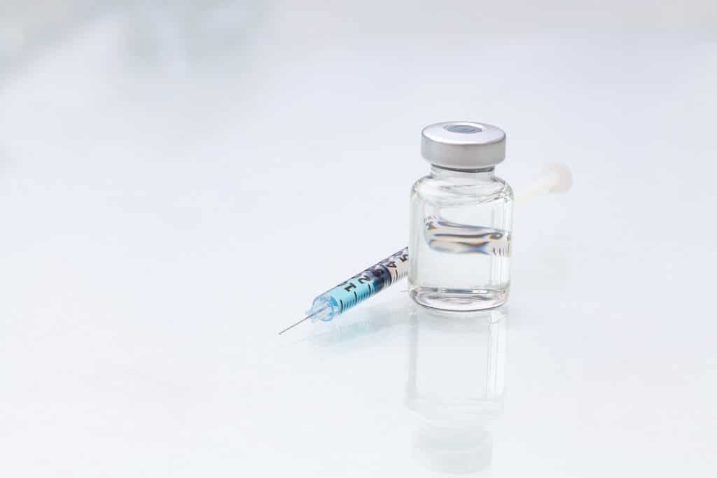 Medical vials for injection with a syringe isolated on white background.