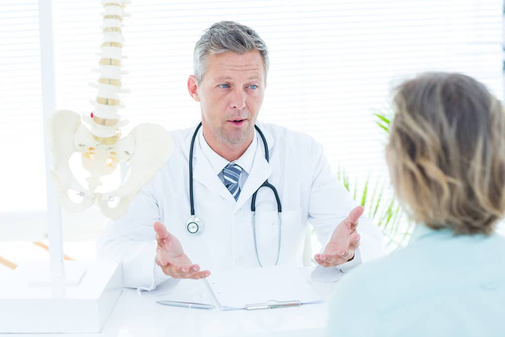 Doctor talking to his patient in medical office