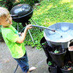 child watering garden