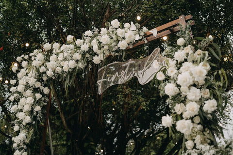 A LED Chuppah Decorated with White Flowers