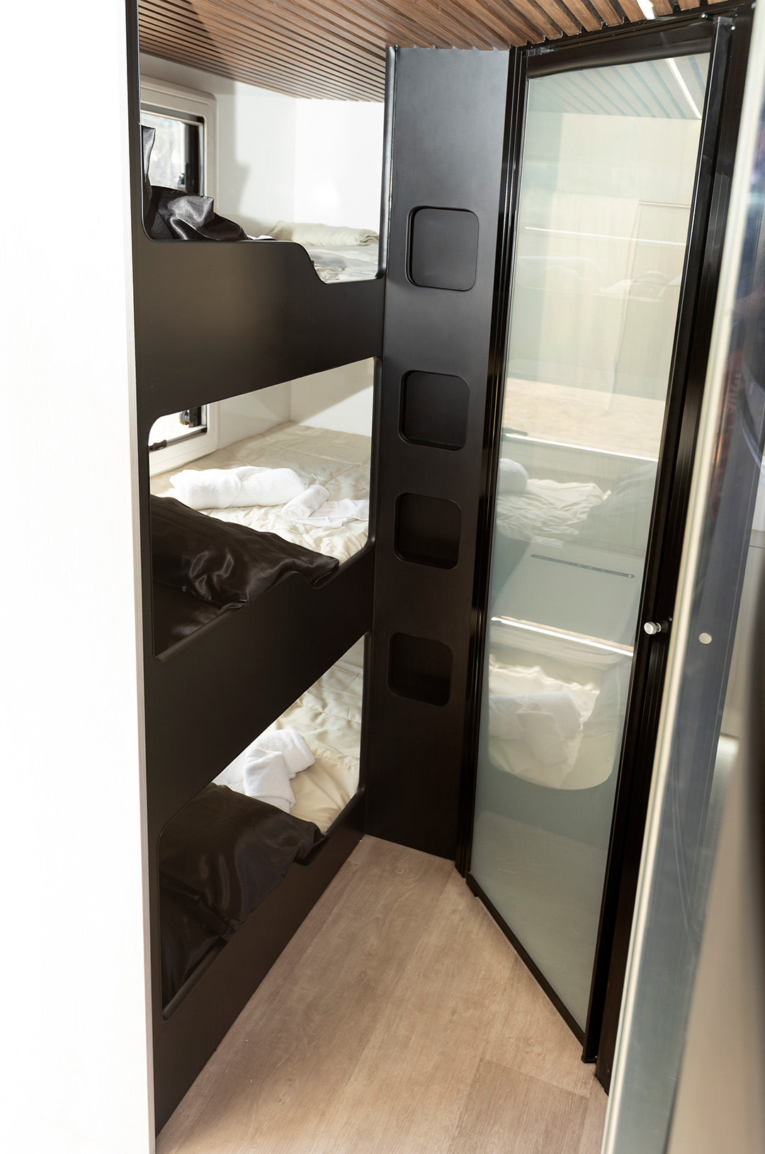 Kids bunks up front next to the ensuite with a door that frosts over with the push of a button
