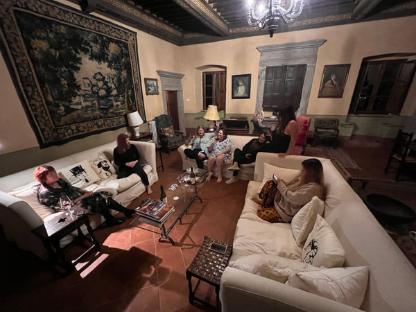 ladies enjoying time in the grand drawing room in the evening