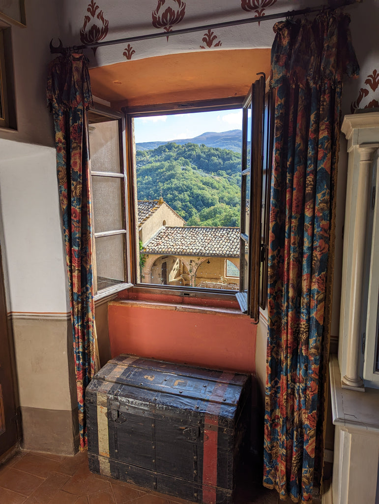 view of a window looking out over castle courtyard