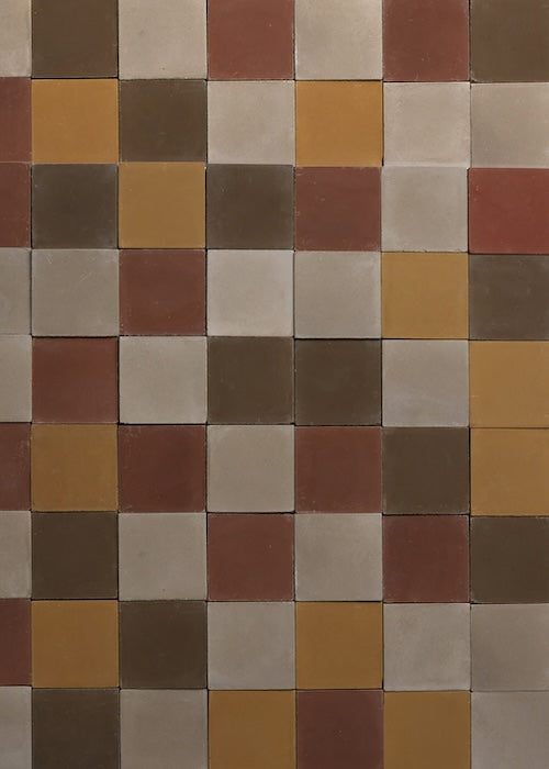 closeup of wall tiled with multicolored square cement tiles
