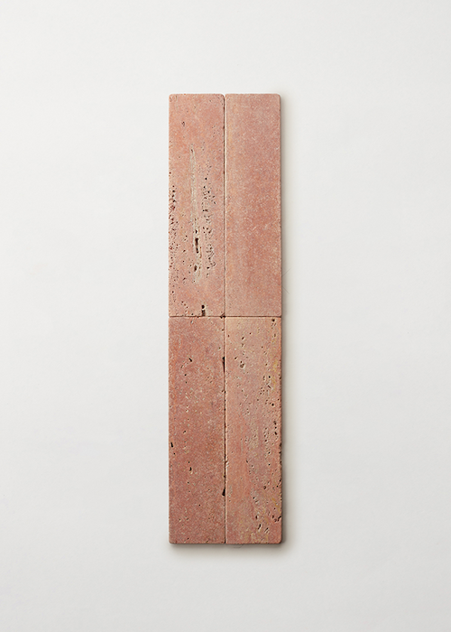 4 rectangular travertine ties against a white surface.