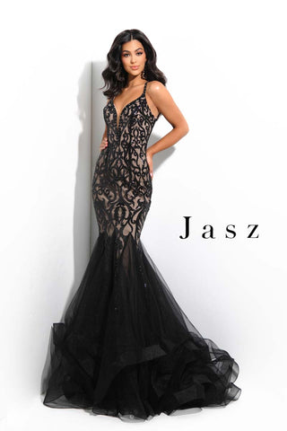 Woman in black mermaid dress by jasz couture featuring a fitted top and tulle skirt