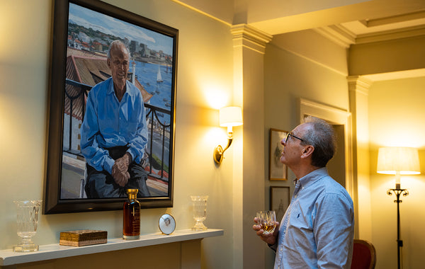 Ian Millar enjoys a whisky in front of a portrait of Charles Gordon