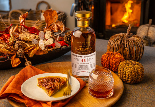 A bottle of the Eight Grain collectable whisky surrounded by pumpkins and pecan pie.