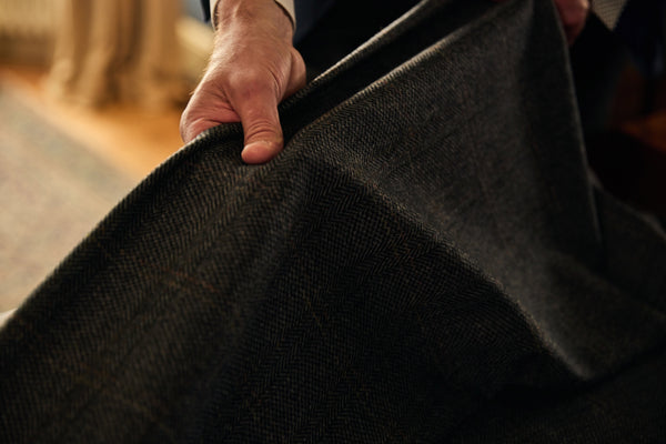 A photo of Campbell showcasing the House of Hazelwood tweed.