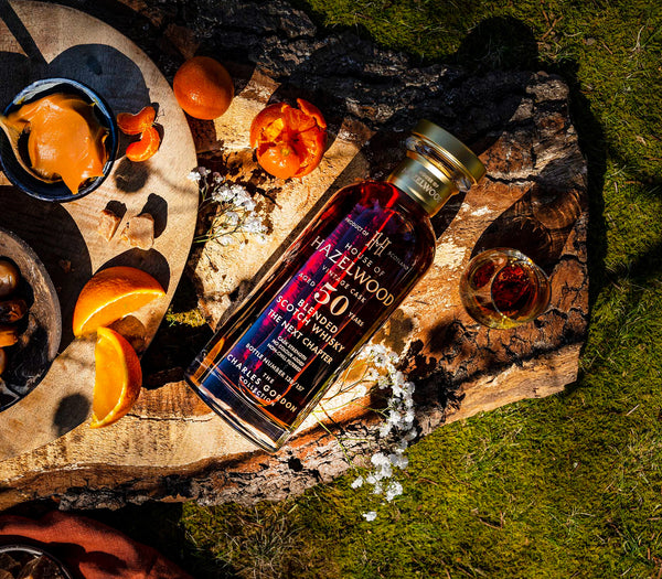 The Next Chapter whisky bottle laid beside elements depicting it's tasting notes.