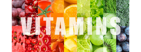 A compilation of fruits and vegetables in a rainbow color pattern overlayed by the word "vitamins"
