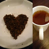 cup of ceylon lovers leap nuwara eliya and tea leaves in heart shape