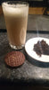 Glass of chocolate tea latte with chocolate biscuit