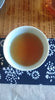 Cup of Da hong Pao on blue and white runner