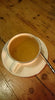 White porcelain cup of Kekecha Golden Dragon Yellow Tea