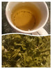 Cup of Kombucha Sencha and spent leaves.