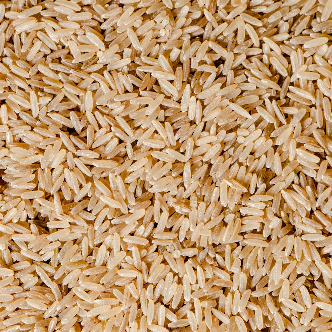 A close-up of uncooked brown rice grains.