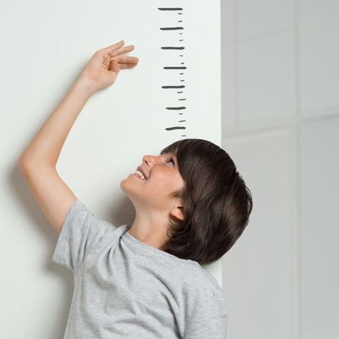 a boy measuring his height