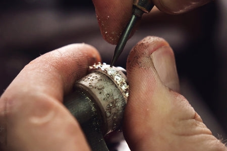 setting diamonds and tightening prongs