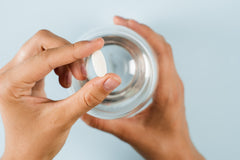 person holding white pill