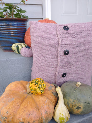 Photo of Friendship Cushion in purple surrounded by pumpkins and gourds.