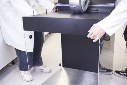 Place the filter panel on top of the laminar flow hood, making sure to align with the slots on the side panel