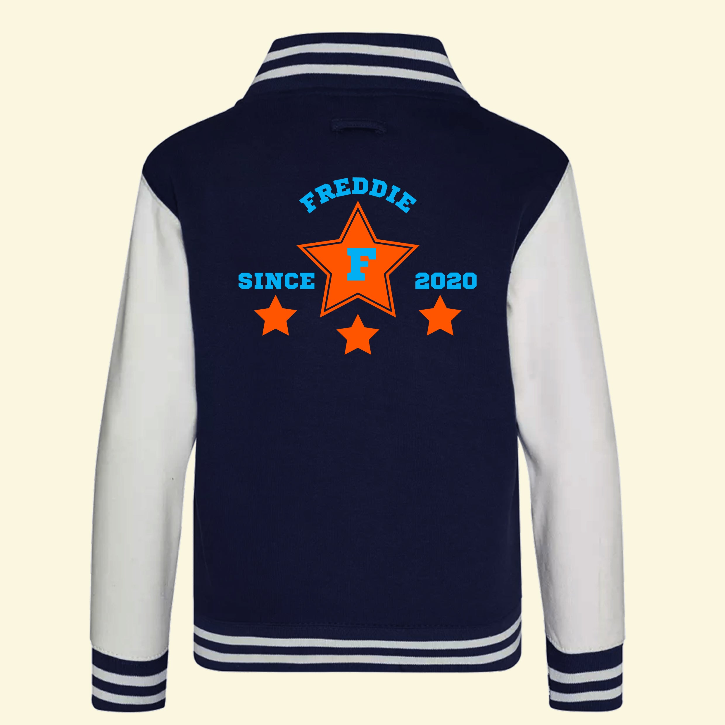 Navy varsity jacket with white sleeves. On the back is a star design and the text Freddie, F and since 2020.