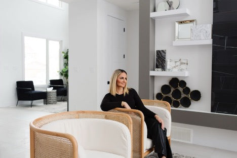Blonde woman sitting on white couch - Interior designer Aness Handous