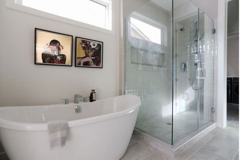 Bathroom with a white bath tub and wall artwork