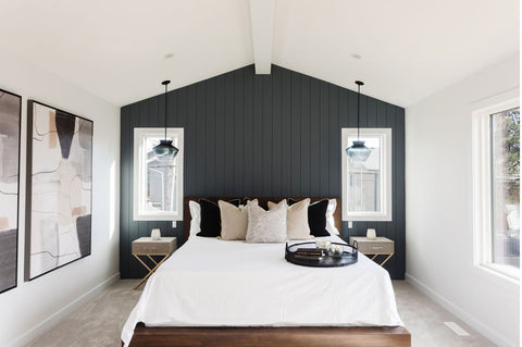 Navy blue wood panel accent wall behind bed