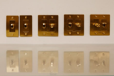 Gold plated knob controls on wall