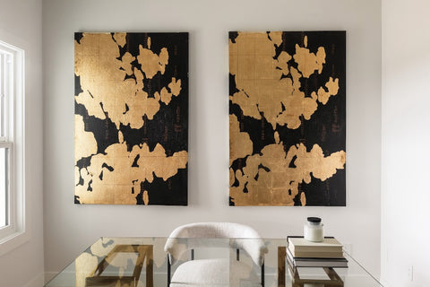 Gold and black wall art hanging above chair