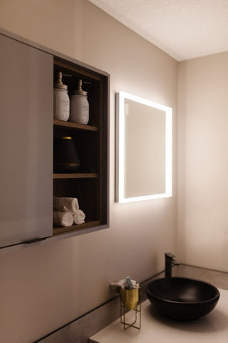 Lit vanity smart mirror on bathroom wall