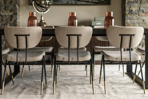 Back of three white dining chairs at kitchen table
