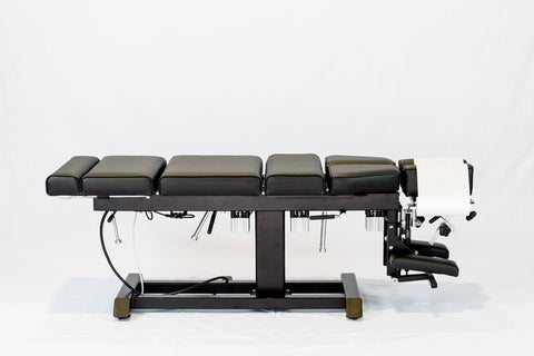 A pneumatic drop table, also known as a chiropractic stationary table.