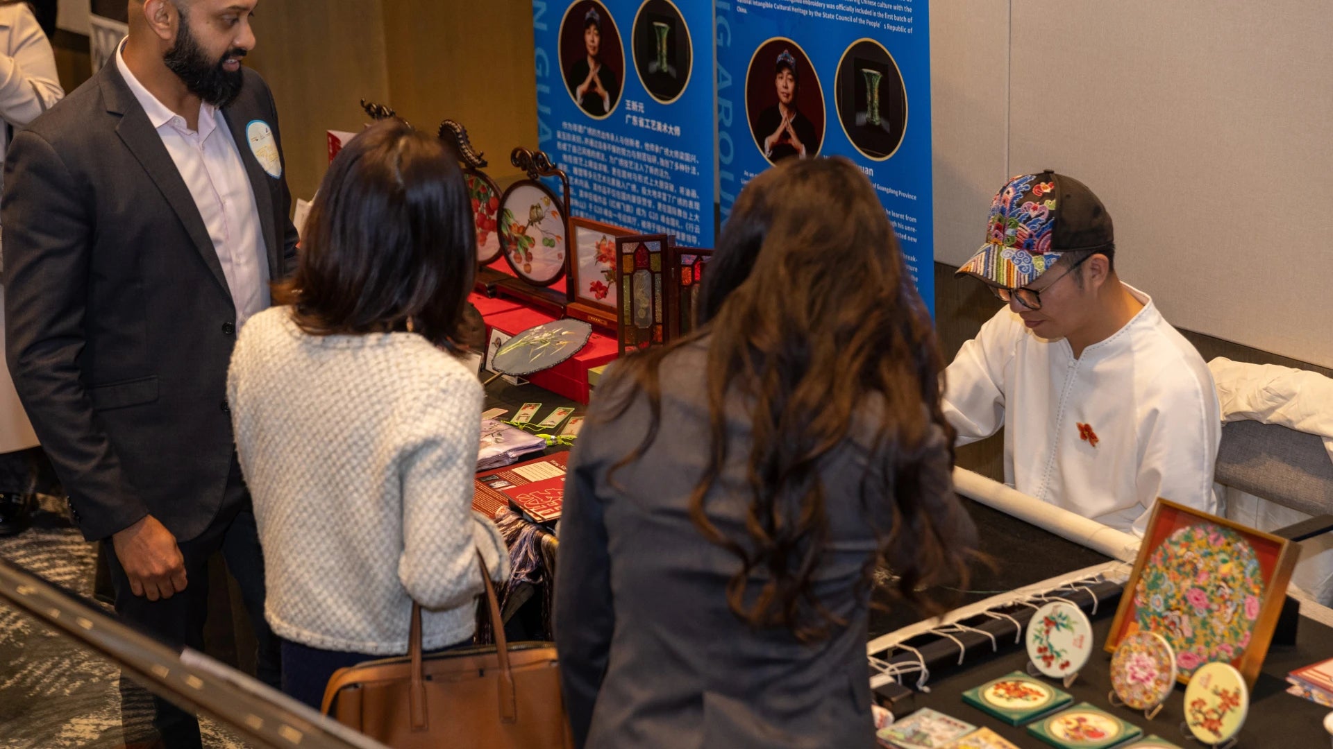 Cantonese embroidery booth with cultural creative gifts on table.