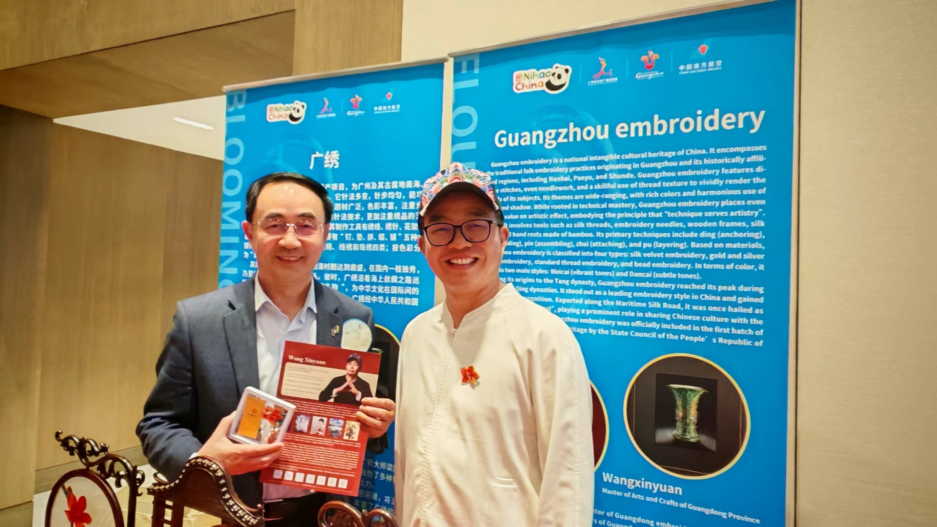 Embroidery master Wang Xinyuan poses with event leaders.
