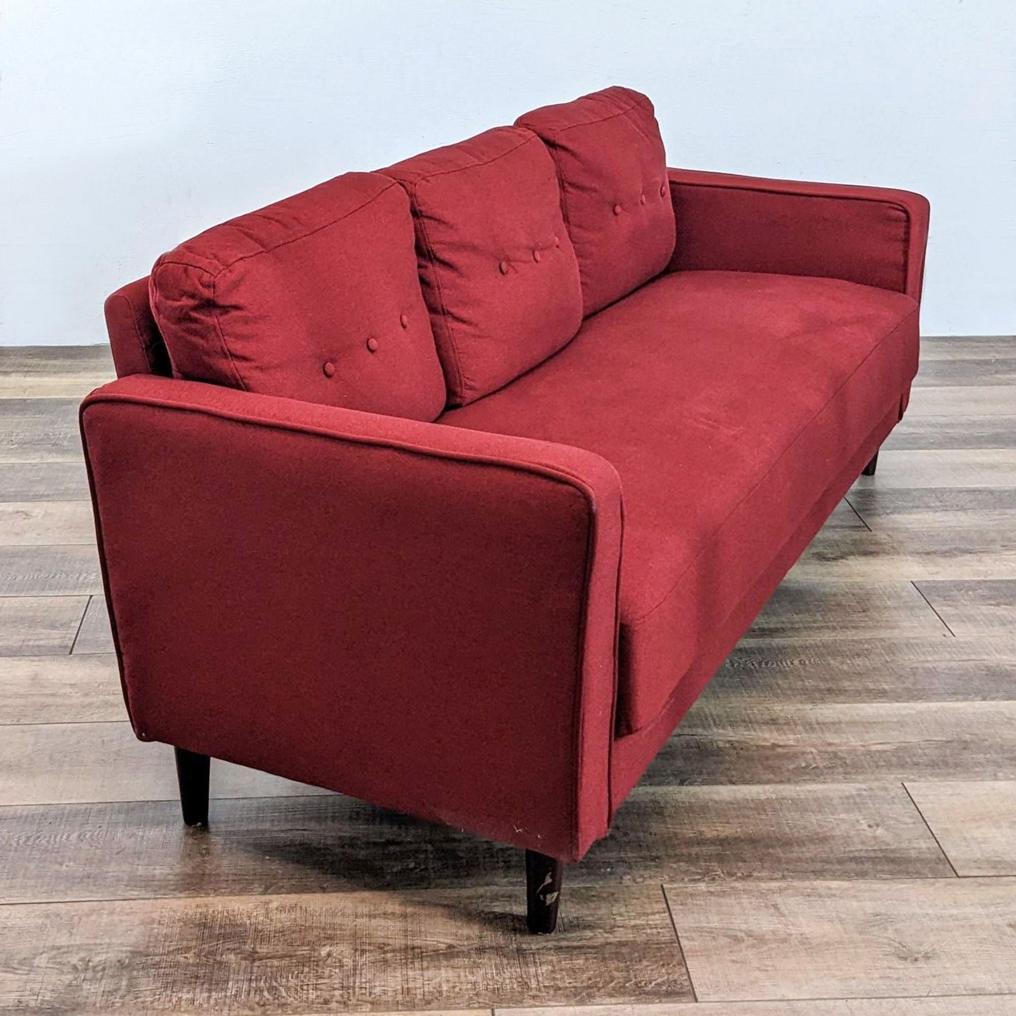 2. Angled view of a Zinus Mikhail 3-seater in red with distinctive track arms and button-tufted cushions.