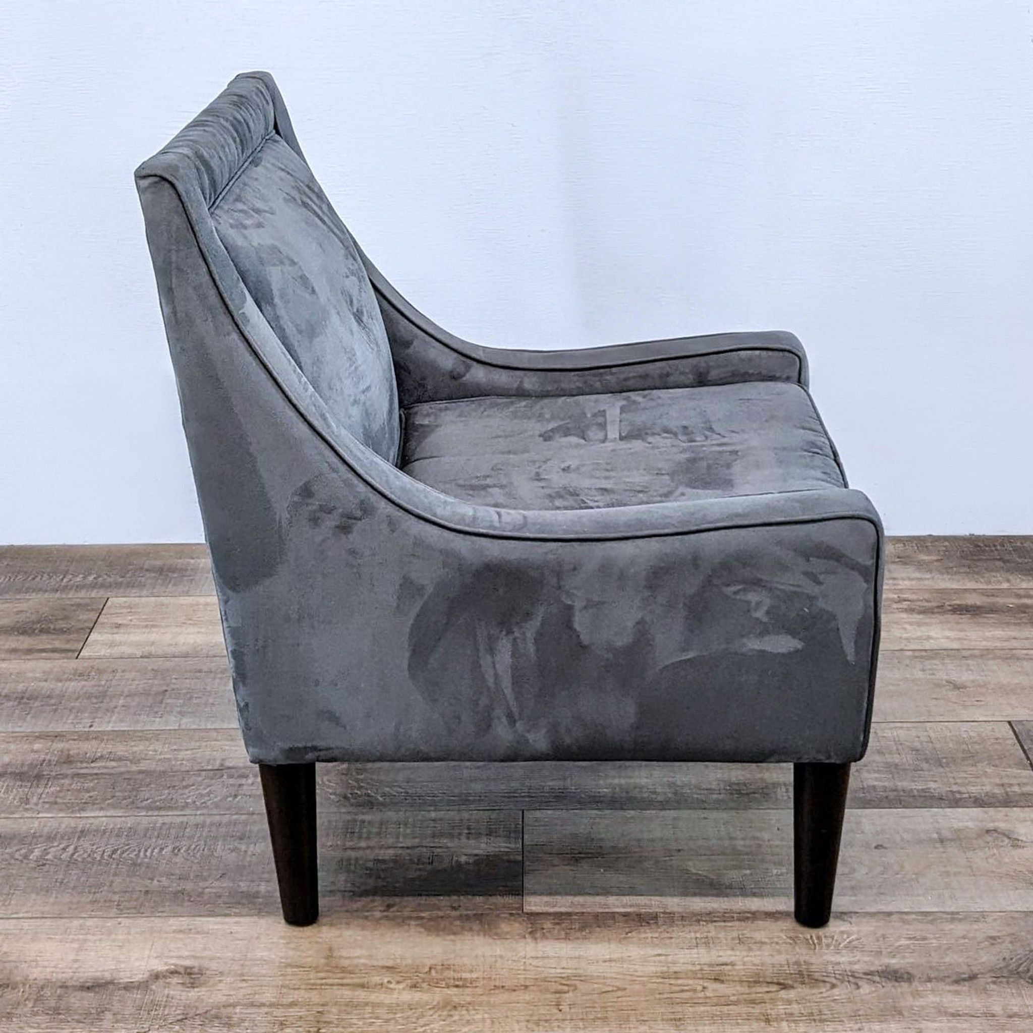 Pair of gray lounge armchairs by Skyline Furniture with elegant narrow arms, comfortable cushioning, and dark tapered legs.