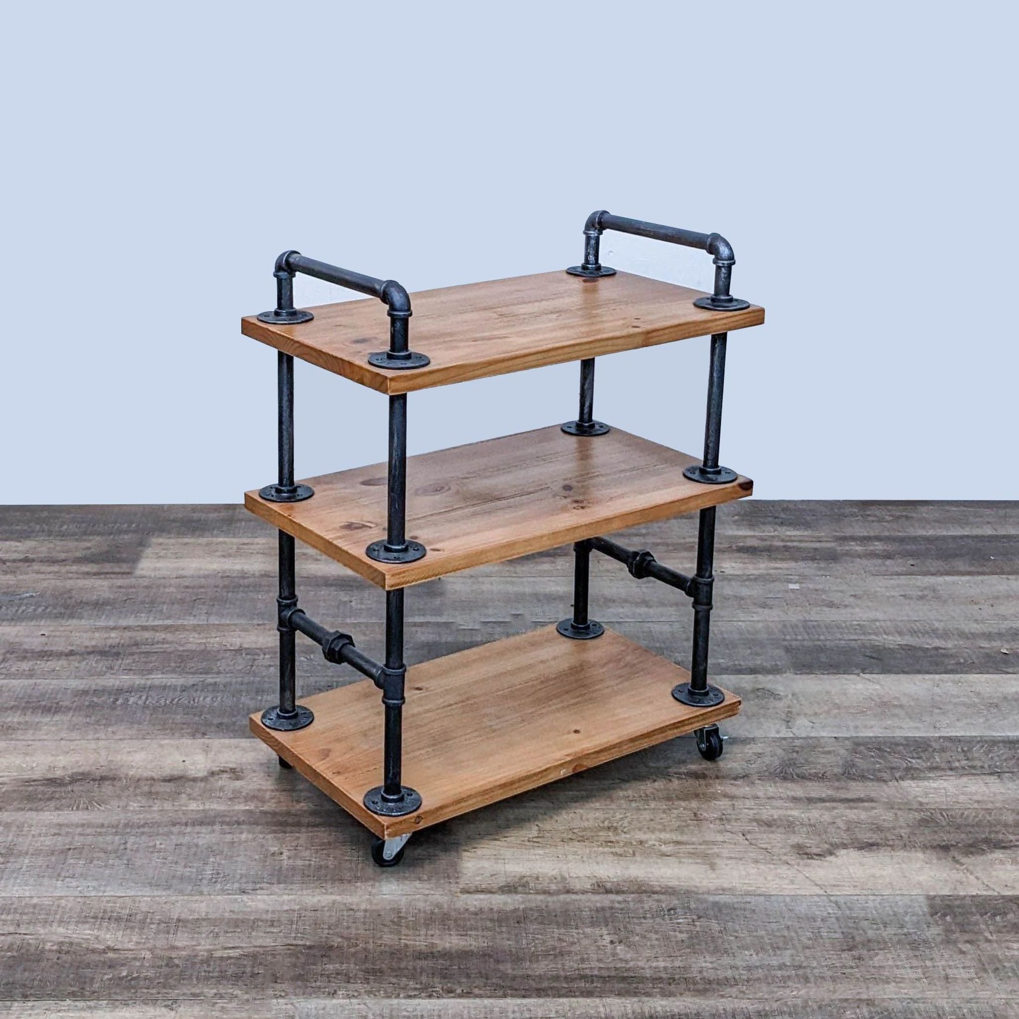 Industrial-style Dofurnilim cart made with wear-resistant wood and heavy-duty water pipe frame, featuring three shelves and wheels.