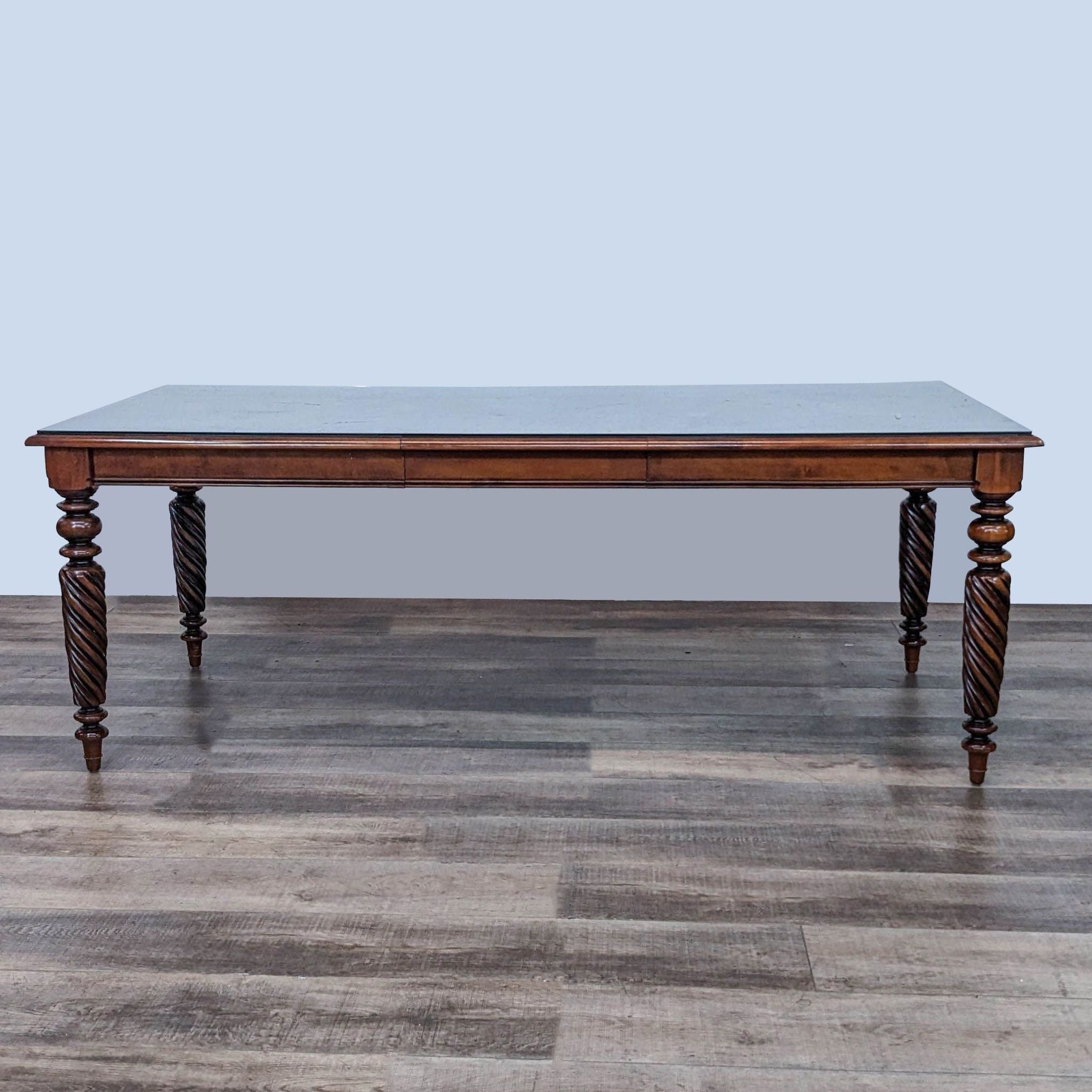 Reperch brand Early American Harvest Style extendable dining table with twisted legs on wood floor.