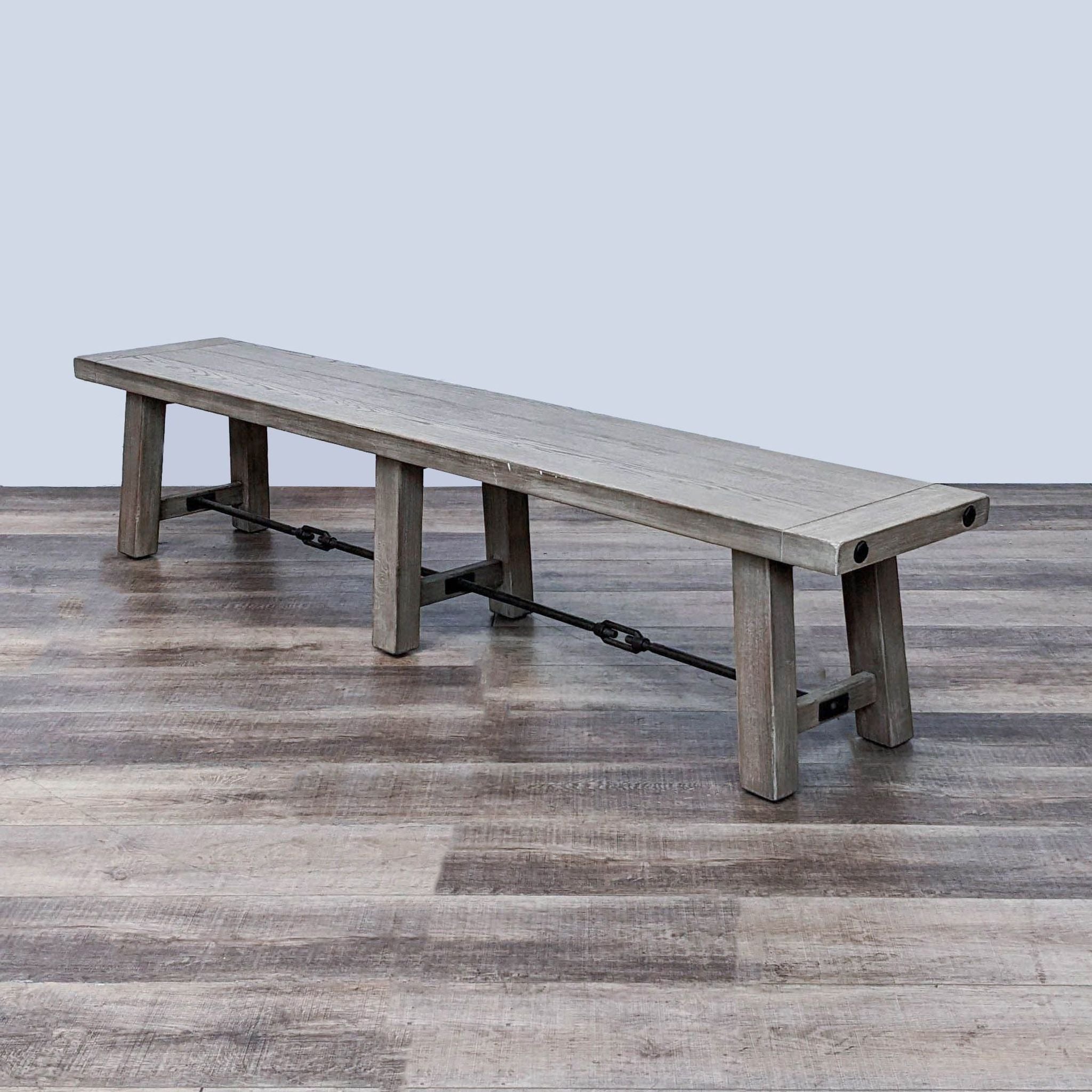 Alt text 1: Pottery Barn rustic wood dining bench with metal accents, set against a hardwood floor background.