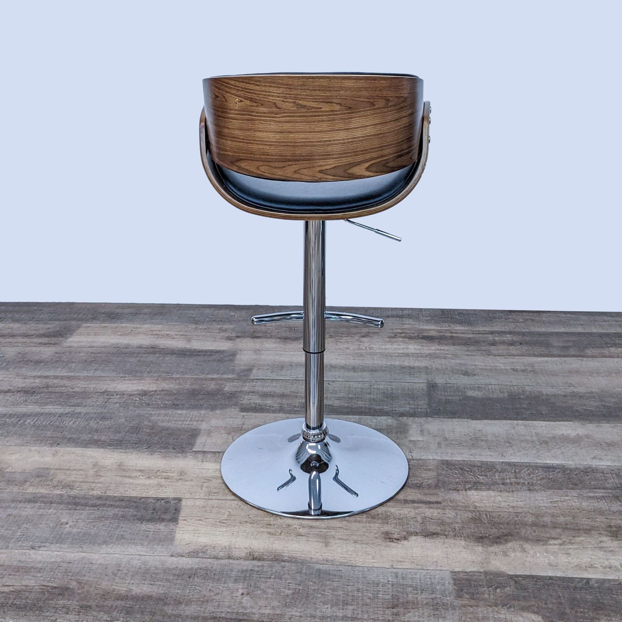 Rear view of Reperch wood finish stool with black padded seat on a sleek chrome base.