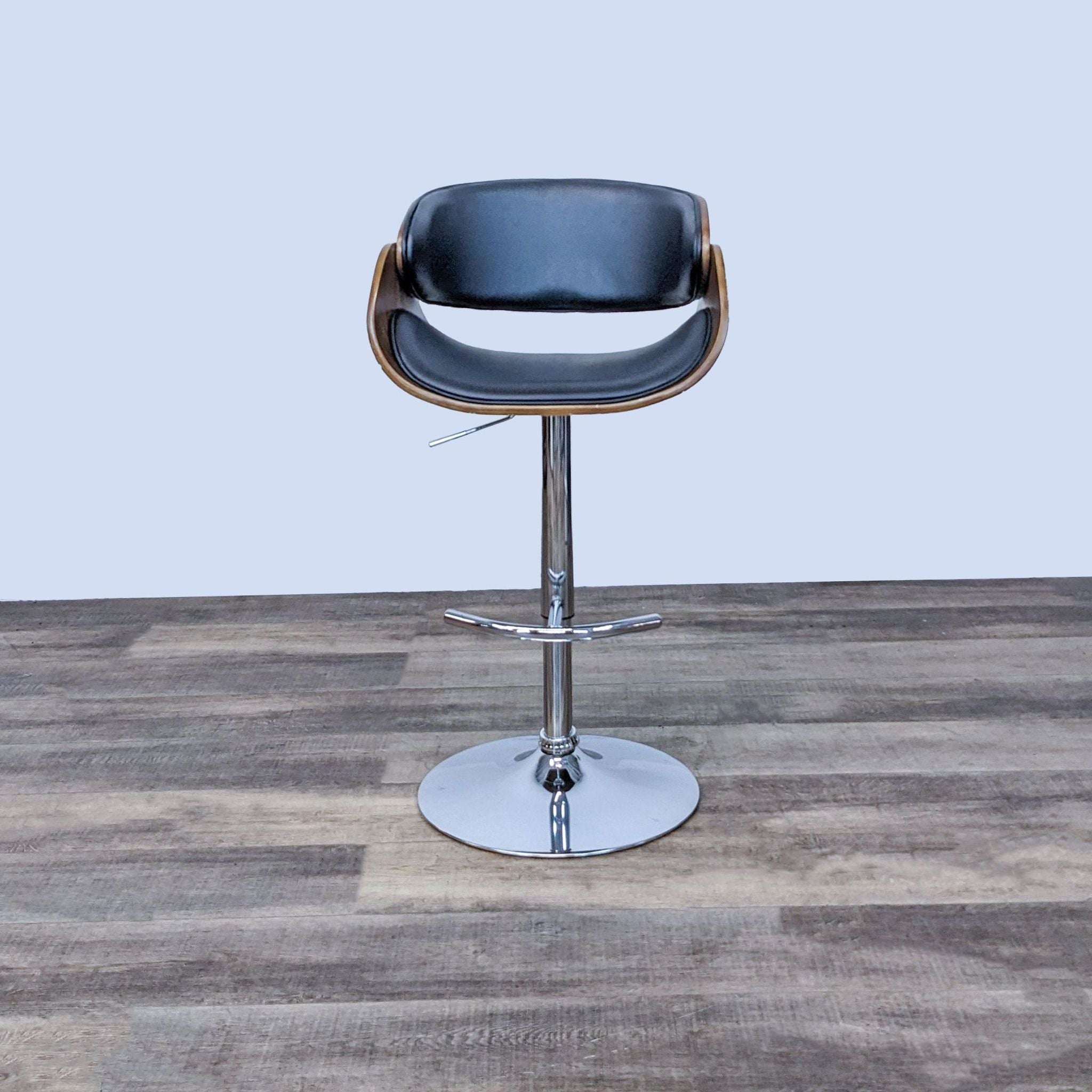 Reperch swivel stool with black seat, curved wooden back, and adjustable chrome base.