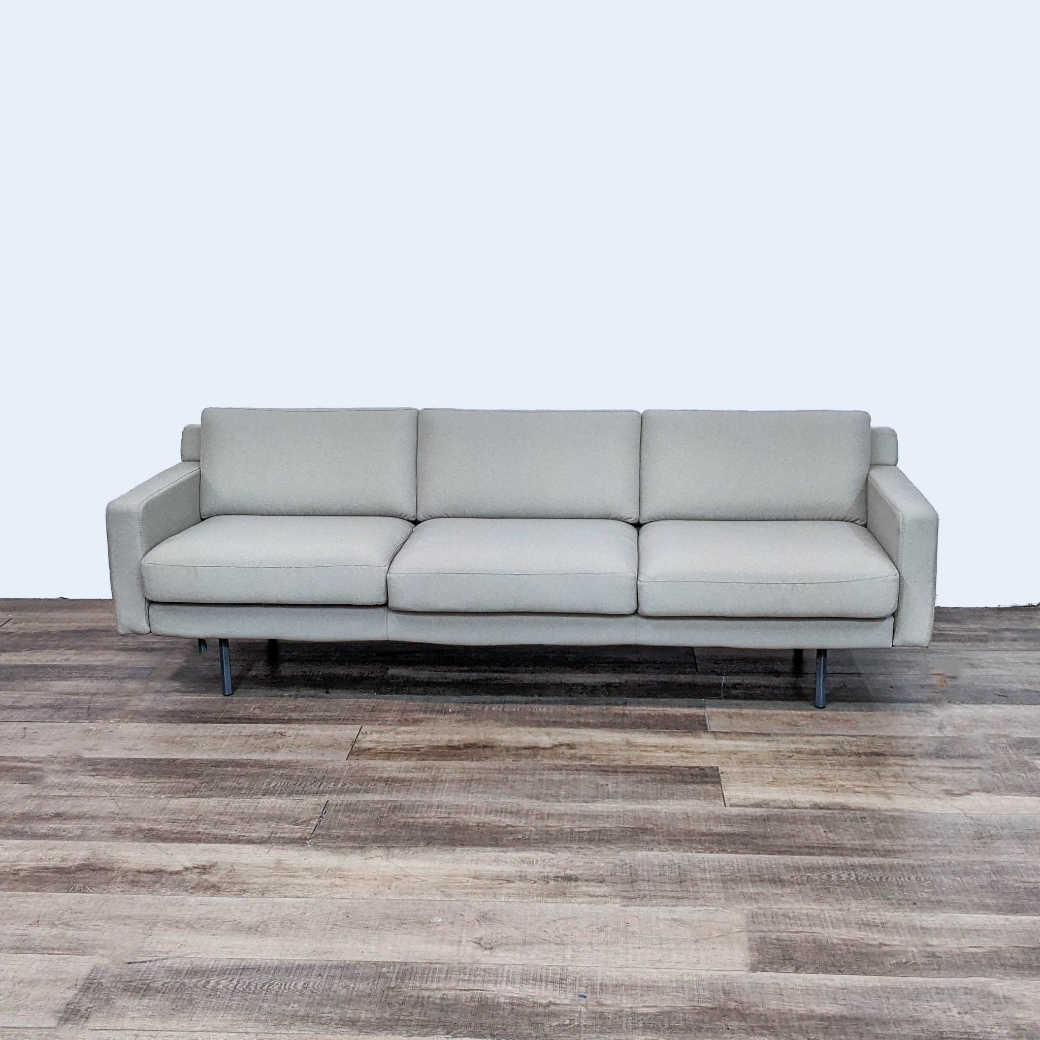 Three-seater minimalist line sofa by Rowe Furniture with square arms and metal legs, displayed from an angled perspective.