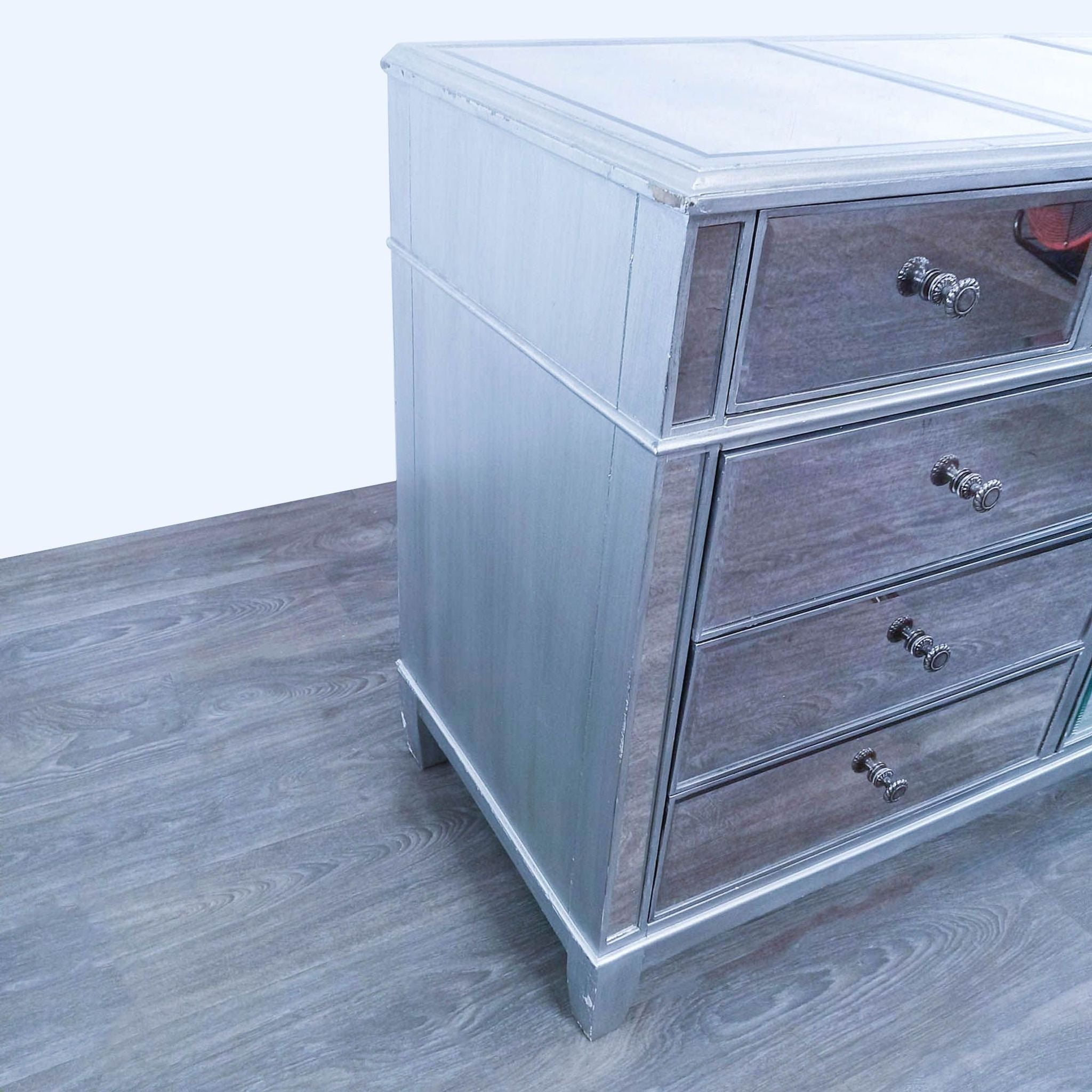 Pier 1 Hayworth mirrored dresser with silver finish and nine drawers on a wooden floor.