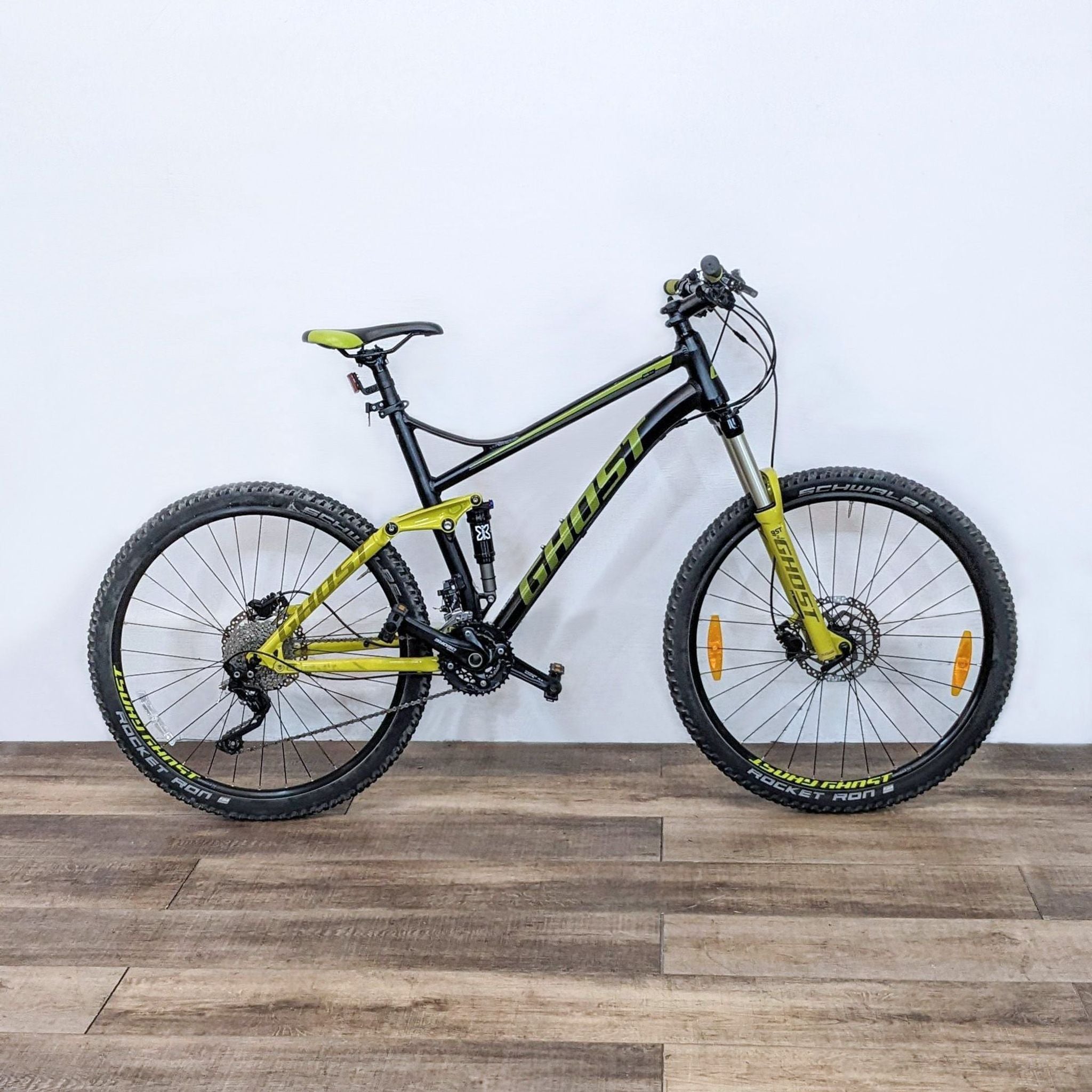 Bright yellow and black REI mountain bike with sturdy full suspension, built for off-road riding and safety.