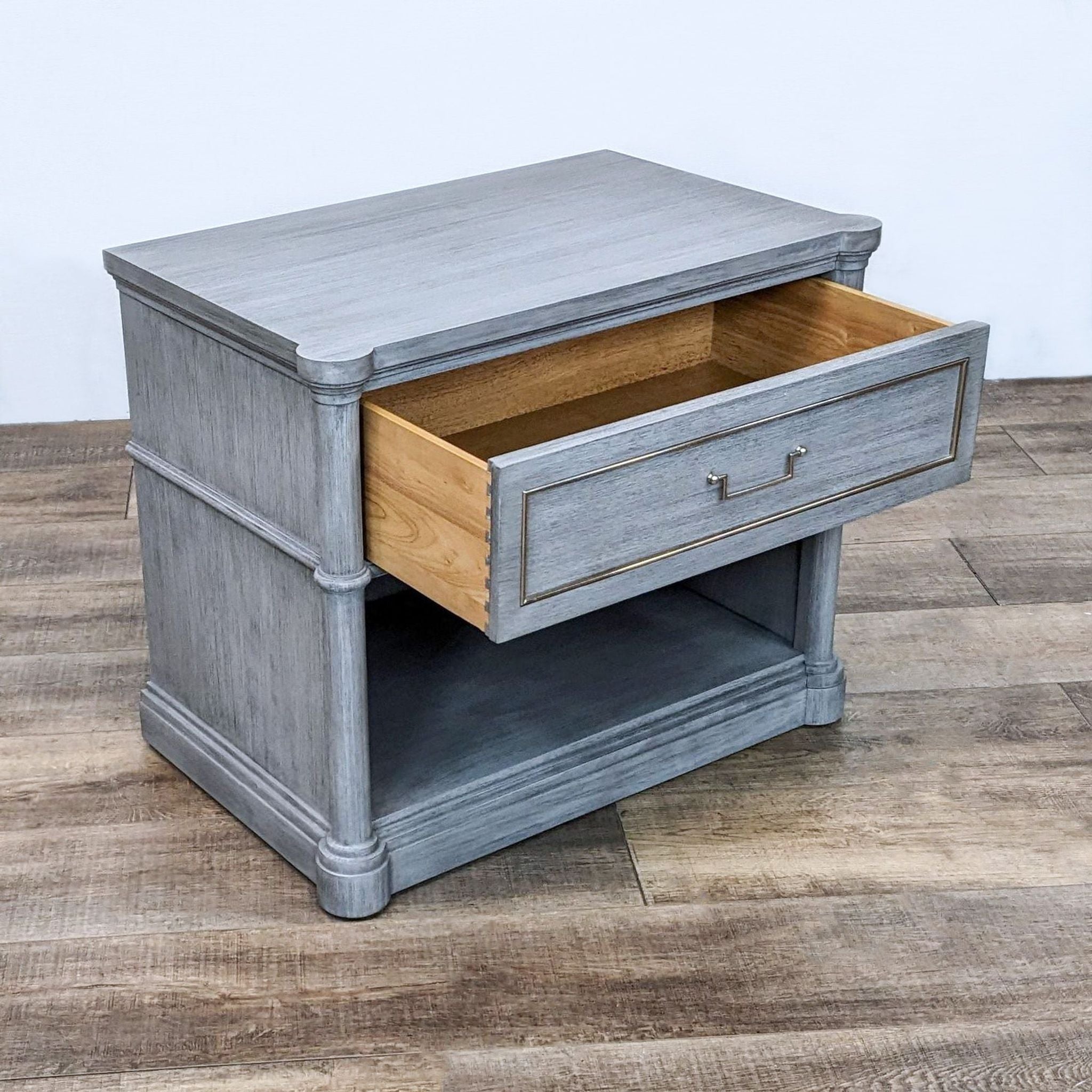 Gray wash Bassett Furniture end table with an open drawer showing wooden interior, metal hardware, and a lower shelf.