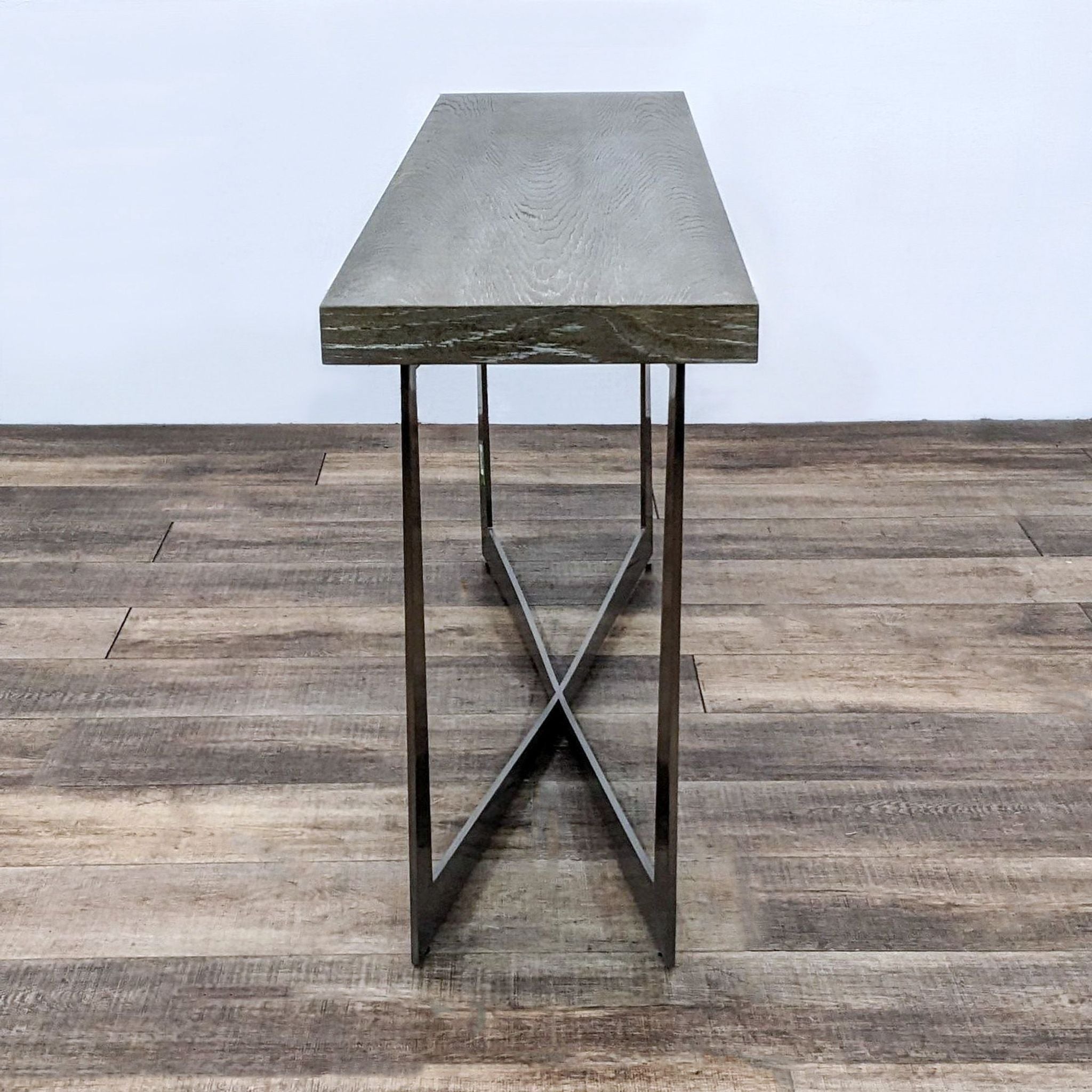 Reperch brand side table with a wood top featuring a rich grain finish and contemporary metal x-base.